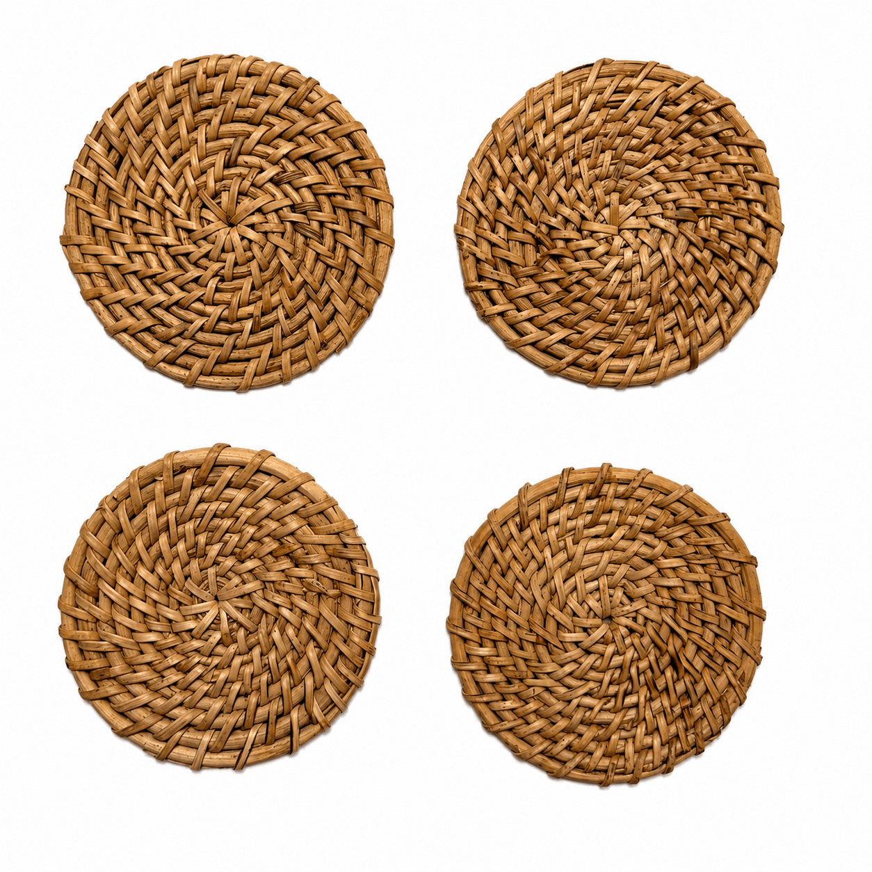Four round woven natural fiber placemats arranged in a 2x2 grid on a plain white background.
