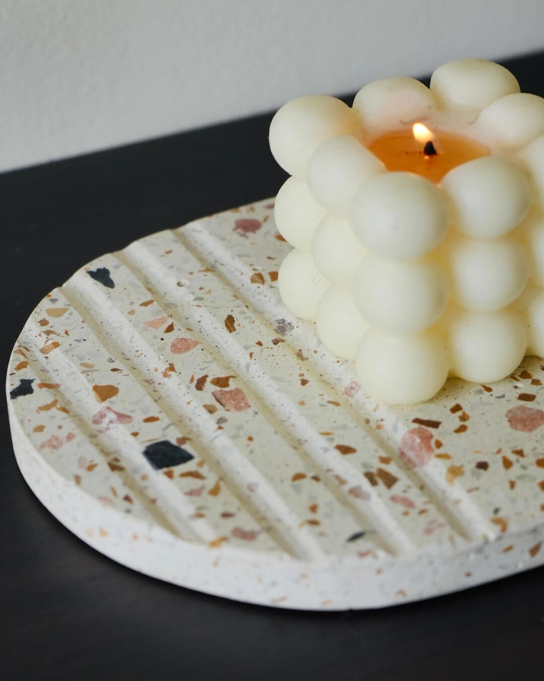 Oval White Terrazzo Trivet with bubble candle